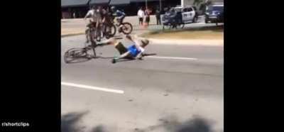 Driver breaks through road block into active cycling race (r/shortclips)