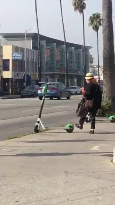 Lady knocks down e-bikes & scooter for no reason
