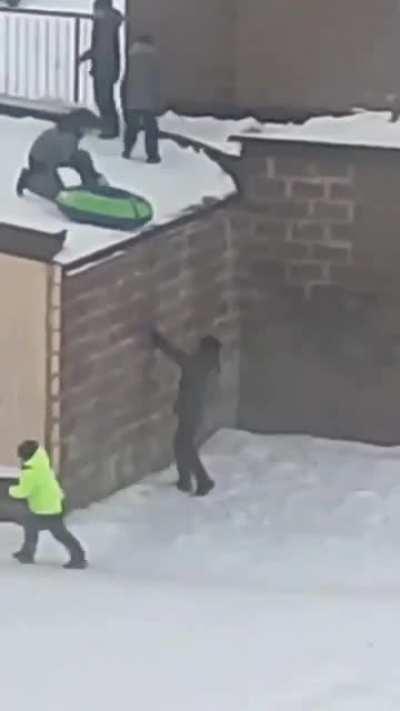 Russian kids having winter fun on a parking lot roof