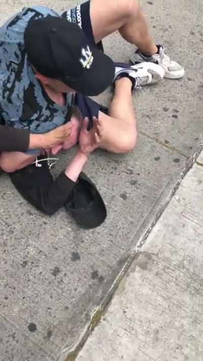Guy chokes out a person who apparently pushed an Asian lady to the ground an broke her front teeth.