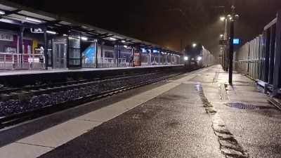 A French TER Régio 2N arriving in the gloomy monday morning rain