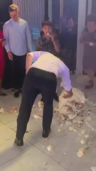 They accidentally dropped their wedding cake, but her husband's reaction confirms she's got a good one.