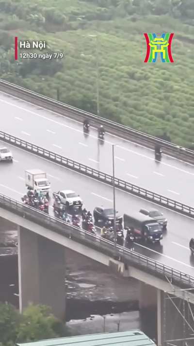 cars shielding bikers in Yagi typhoon