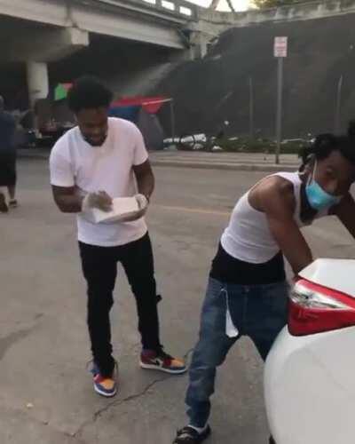 Men in Miami filled their trunk with food to hand out to the homeless.