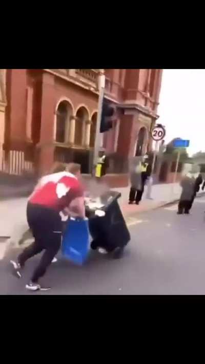 Throwing a burning trash can at the police