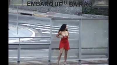 Beautiful brunette shows her tits and pussy on the street