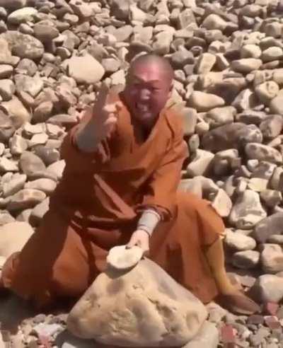 Monk breaks stones using only fingers