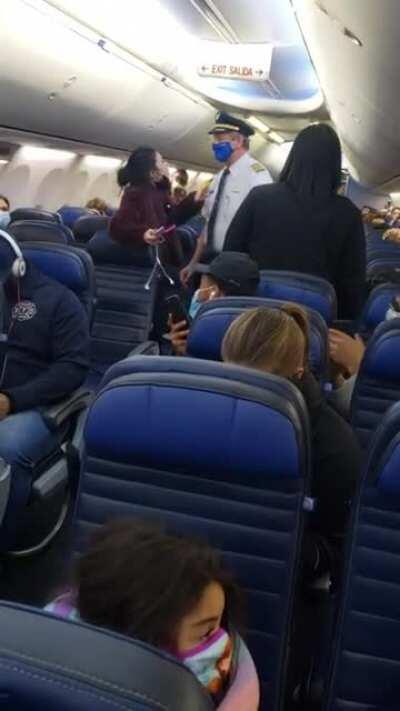 Karen doesn’t know why she’s being kicked off the plane.