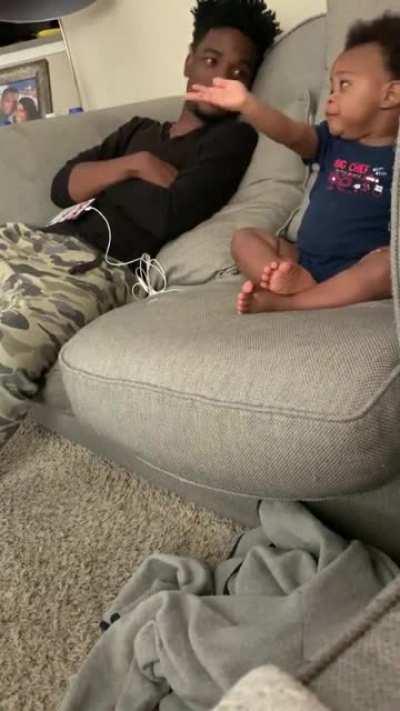 This adorable baby having a full-fledged conversation with Daddy