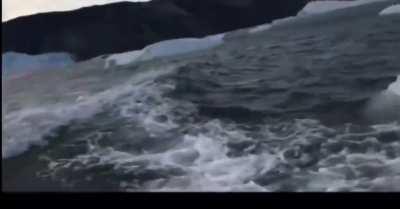 Small boat, big tsunami. (Glacial calving and berg roll)