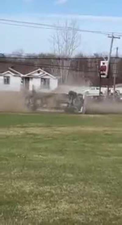 Dude in a truck chased by police drives in the ditch, obliterates an electric post and does a barrel roll.