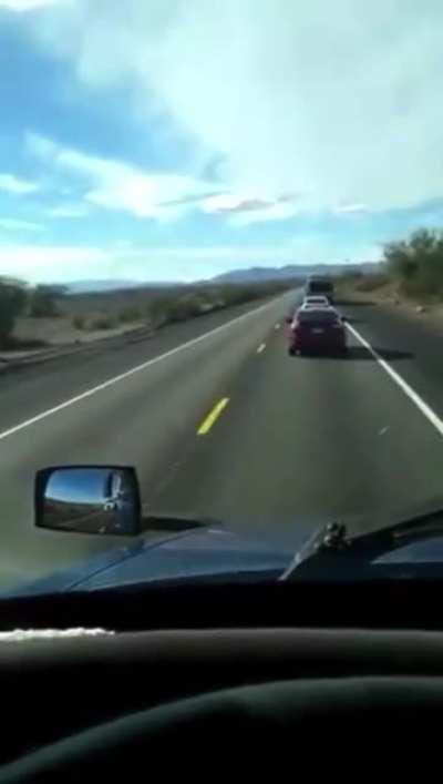 Swift Transportation driver passes on a 2 lane road forcing oncoming cars onto the shoulder