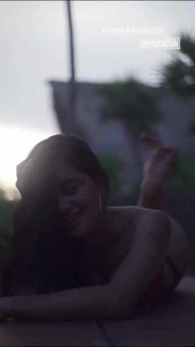 On stomach, slight view of thong/booty