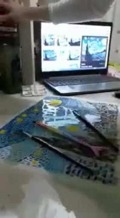 Girl accidently spills water over her painting