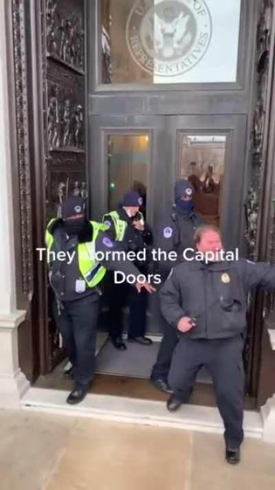 Police defending the doors to the Capital building