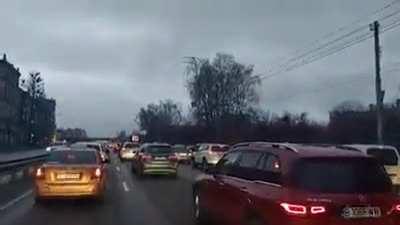 Air raid sirens as refugee convoy hits traffic on outskirts of Kyiv