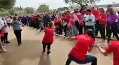 Participating in a women's tug of war competition