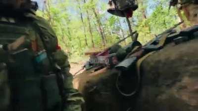 Russian marines take cover in a trench as artillery lands nearby