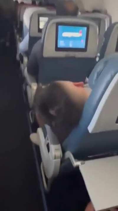Dude dumps water on sleeping airplane passenger
