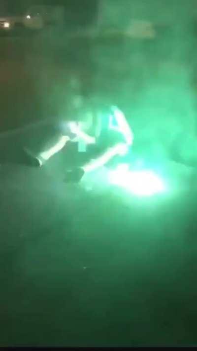 This young man having a seizure and trying to let people shooting fireworks at him know