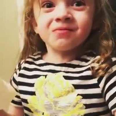 Daughter pretending to enjoy spaghetti