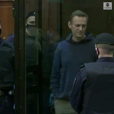 Alexey Navalny makes a heart gesture as his wife and supporters look on while a Russian court orders the opposition leader to more than two years in a prison camp.