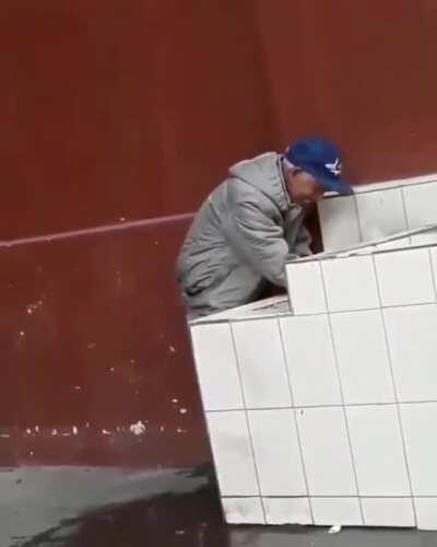 An elderly gentleman helping out a thirsty street doggo