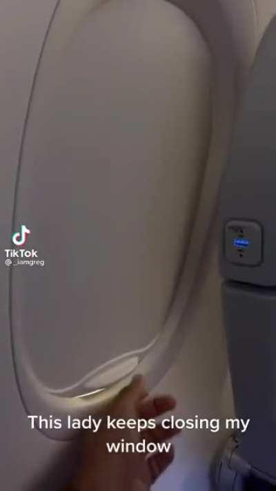 Closing a window seat window that isn’t yours.