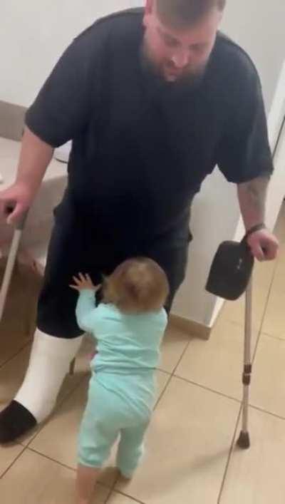 Toddler helps take care of her dad
