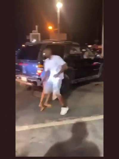 Guy tries to punch a woman but runs into a car instead