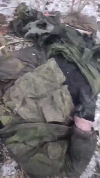 Russian soldiers examine the torn bodies of their comrades after an FPV drone attack on their position in Donetsk Oblast. Part 1