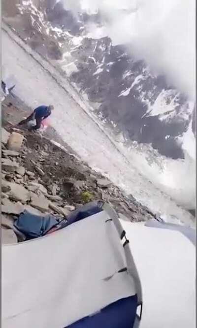 Boulder tumbling down the mountain nearly misses hiker