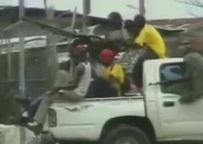 A technical packed with combatants is hit by sustained gunfire Liberia, Africa