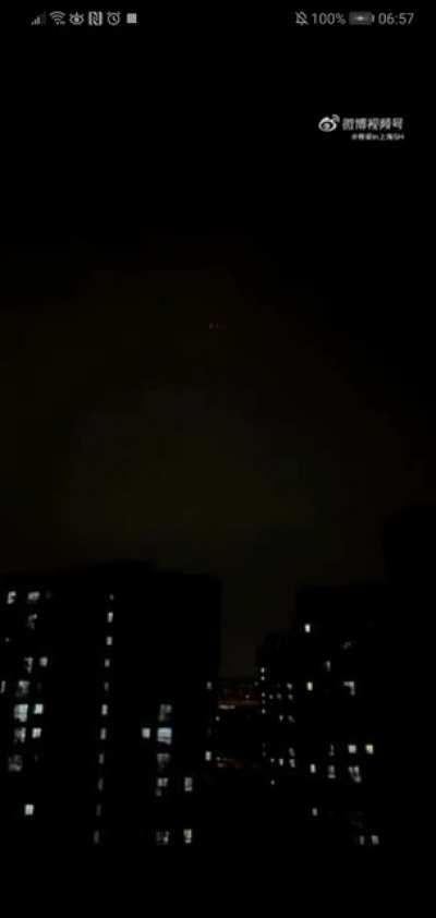 Shanghai residents go to their balconies to sing and protest lack of supplies. A drone appears: 