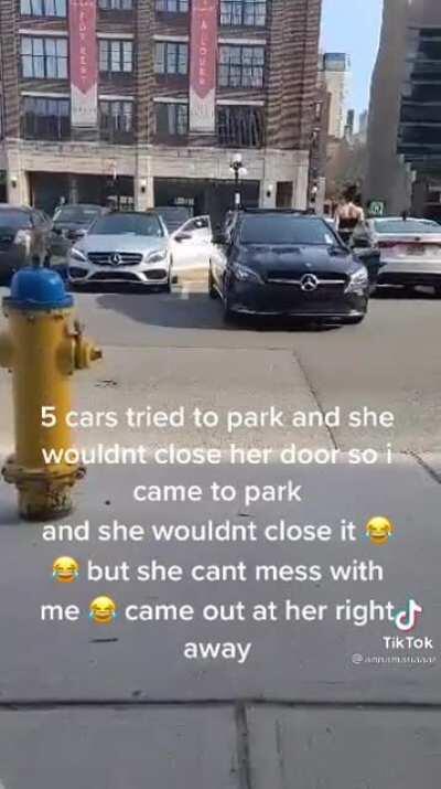 Jerk won’t close her door so people can park. She is very bold until she meets someone sick of her crap