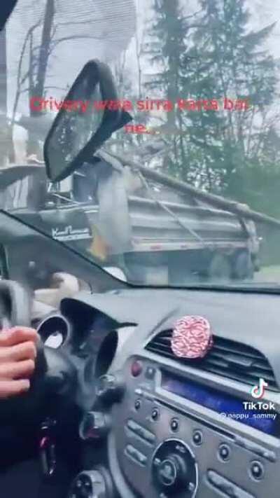 Kam Bhullar trucking, casually dragging a log and power line down the road in to oncoming traffic