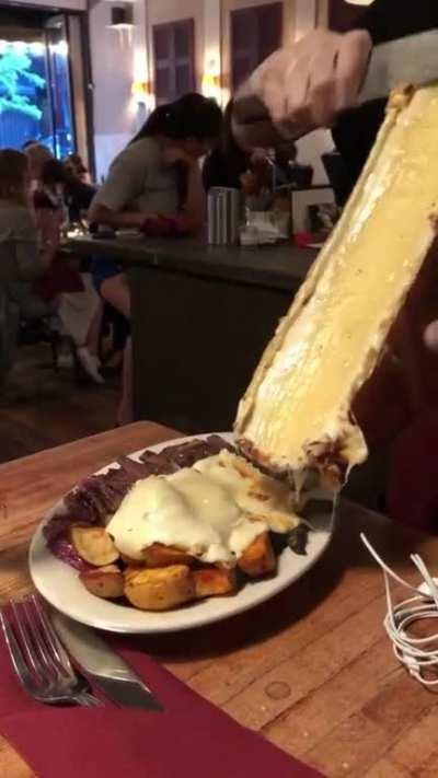 Melted Raclette cheese wheel