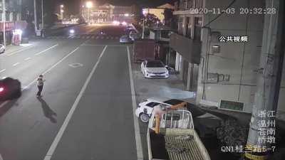 Darwin Contender Stands in the middle of the road on his phone oblivious of the passing cars...