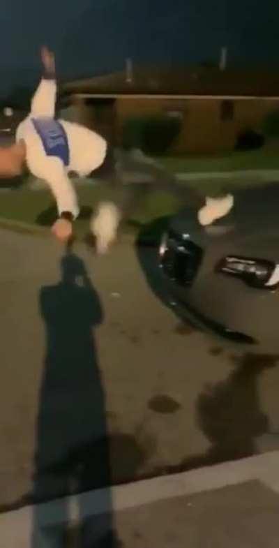 Trying to do a backflip from the hood of a car