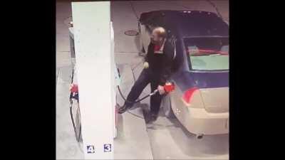 Guy assaulting a fuel pump.
