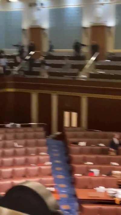 Video from inside the US Capitol chamber, police in an armed standoff with protestors outside the door