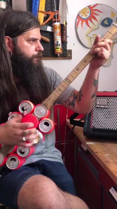 Guy kills it on a guitar made of beer cans