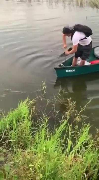 Standing up in a canoe.