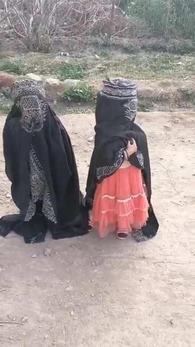 A father tells his daughter that a man is coming and they immediately cover their faces