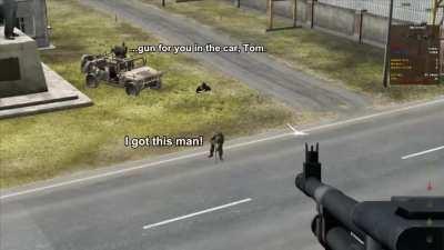 He is pointing his gun AT the road