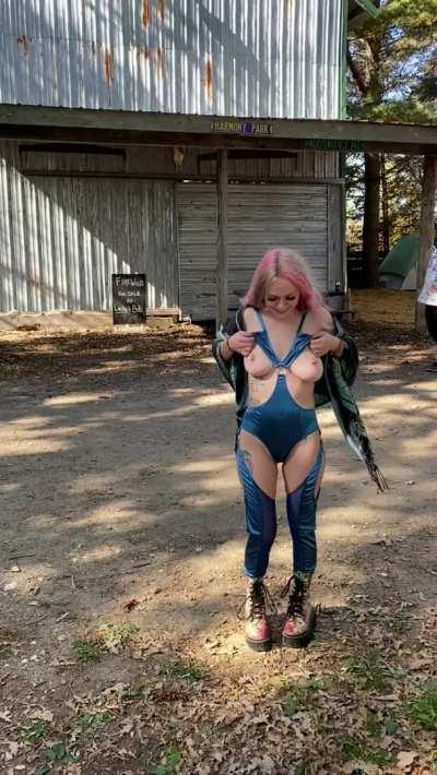 just an exhibitionist slut flashing her titties to everyone entering the festival