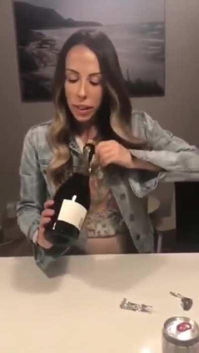Opening a bottle of champagne while pointing it at your face