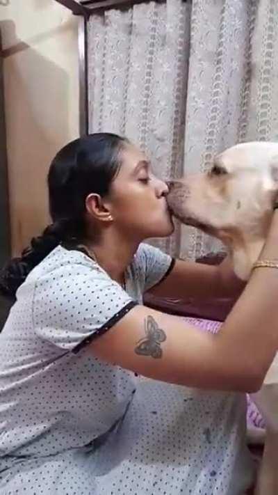 Dog kissing mommy