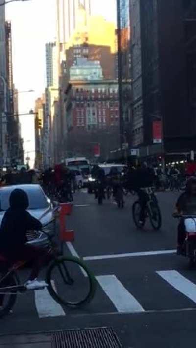Earlier today in Manhattan, a group of people on bikes blocked a street and smashed up a car waiting at the intersection.