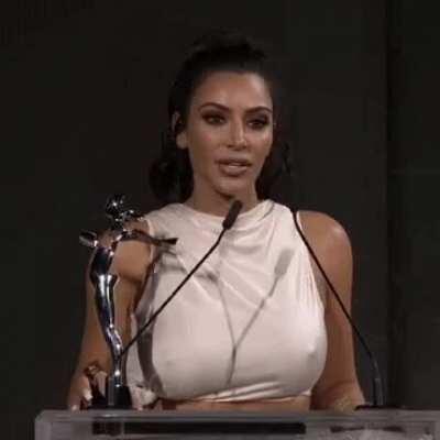 Her nips erect while holding a speech.
